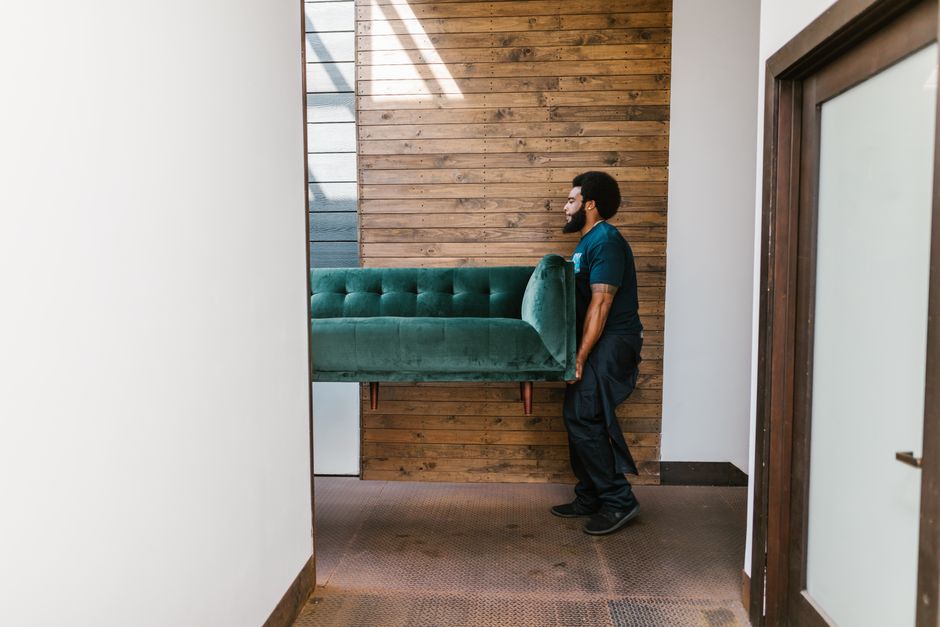 Strong movers carrying heavy furniture safely